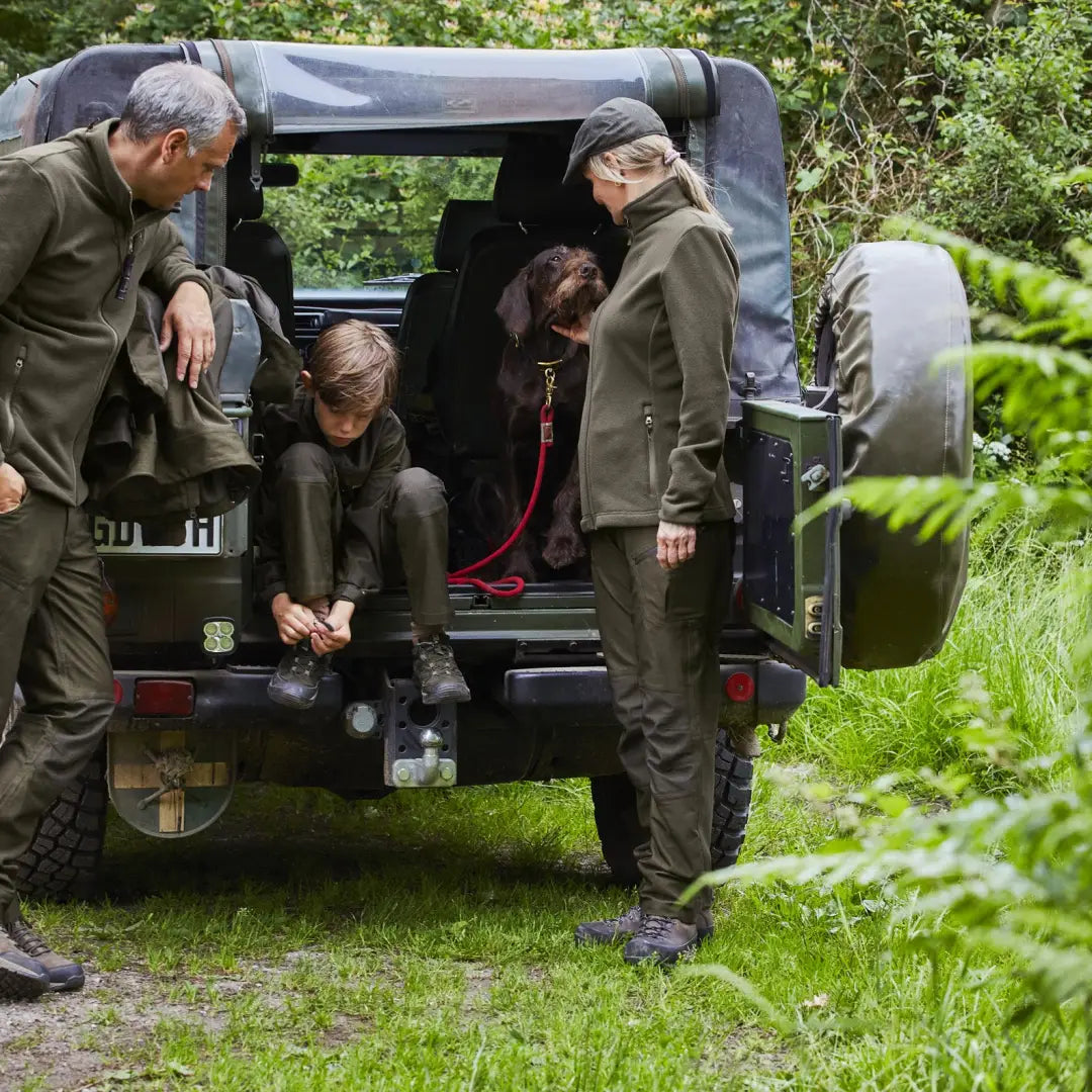 Military off-road vehicle with people, featuring the Deerhunter Lady Chasse Fleece Jacket