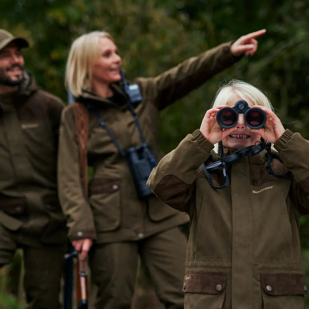 Three friends in outdoor gear, observing nature while showcasing the Lady Eagle Jacket