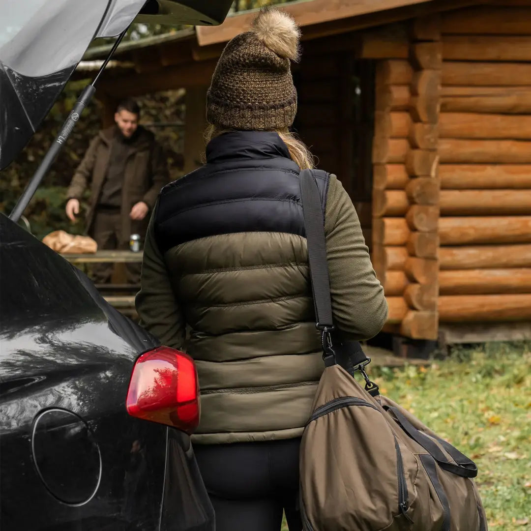 Person in a puffy vest and knit hat with a car, showcasing Lady Northward Padded Waistcoat