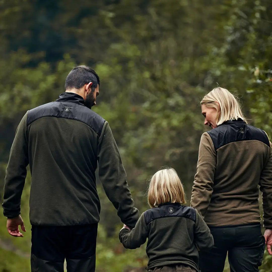 Family enjoying nature while wearing the cozy Northward Fleece Jacket, holding hands