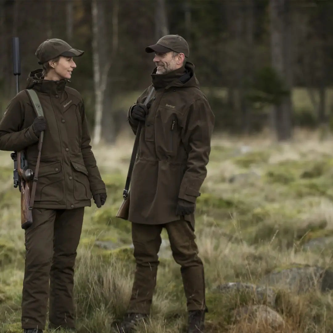 Two people in dark jackets showcasing Deerhunter PRO Gamekeeper Smock in the field