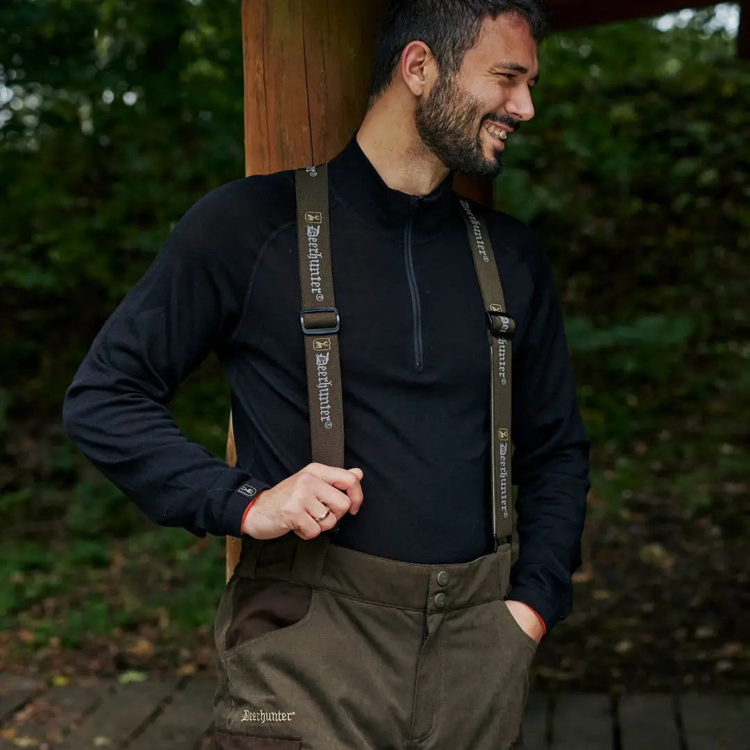 Man in dark outdoor gear and waders showcasing Deerhunter Quinn Merino ½-Zip Undershirt