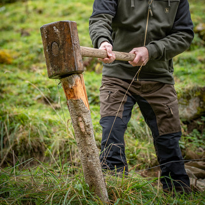 Man hammering a wooden post while wearing Rogaland Contrast Stretch Trousers