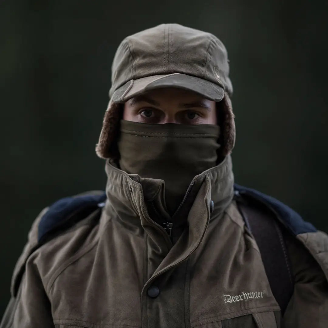 Person in a winter hat and face mask using the Rusky Silent Neck Tube in low light