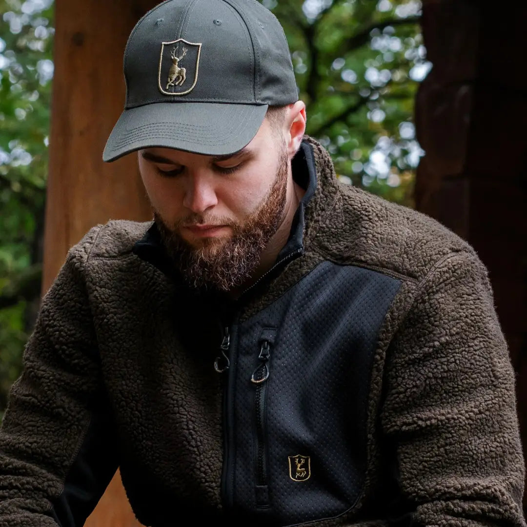 Bearded man in a gray cap and fleece jacket rocking the Deerhunter Shield Cap