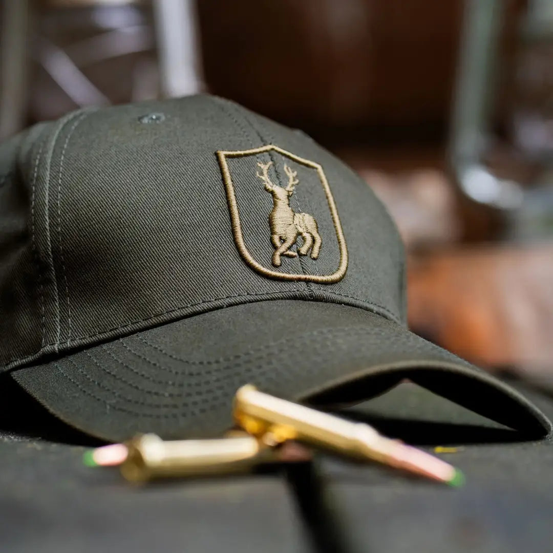 Green Deerhunter Shield Cap with a deer emblem, perfect for country clothing style