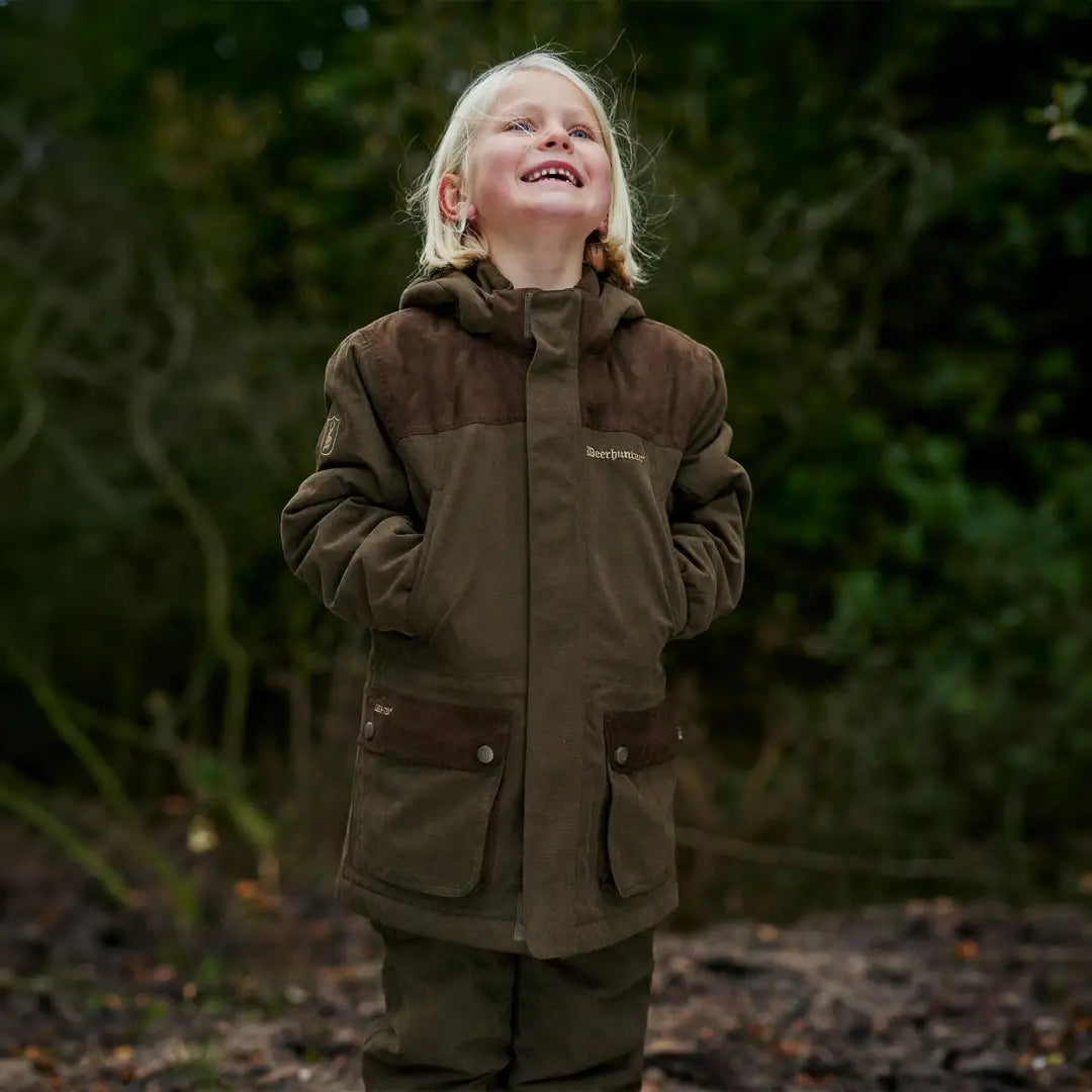 Child smiling in Deerhunter Youth Eagle Winter Jacket, perfect for chilly days