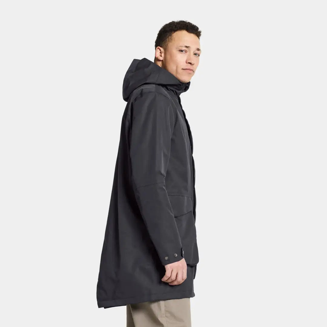 Dark gray hooded Didriksons Andreas Parka worn by a person in rainy weather