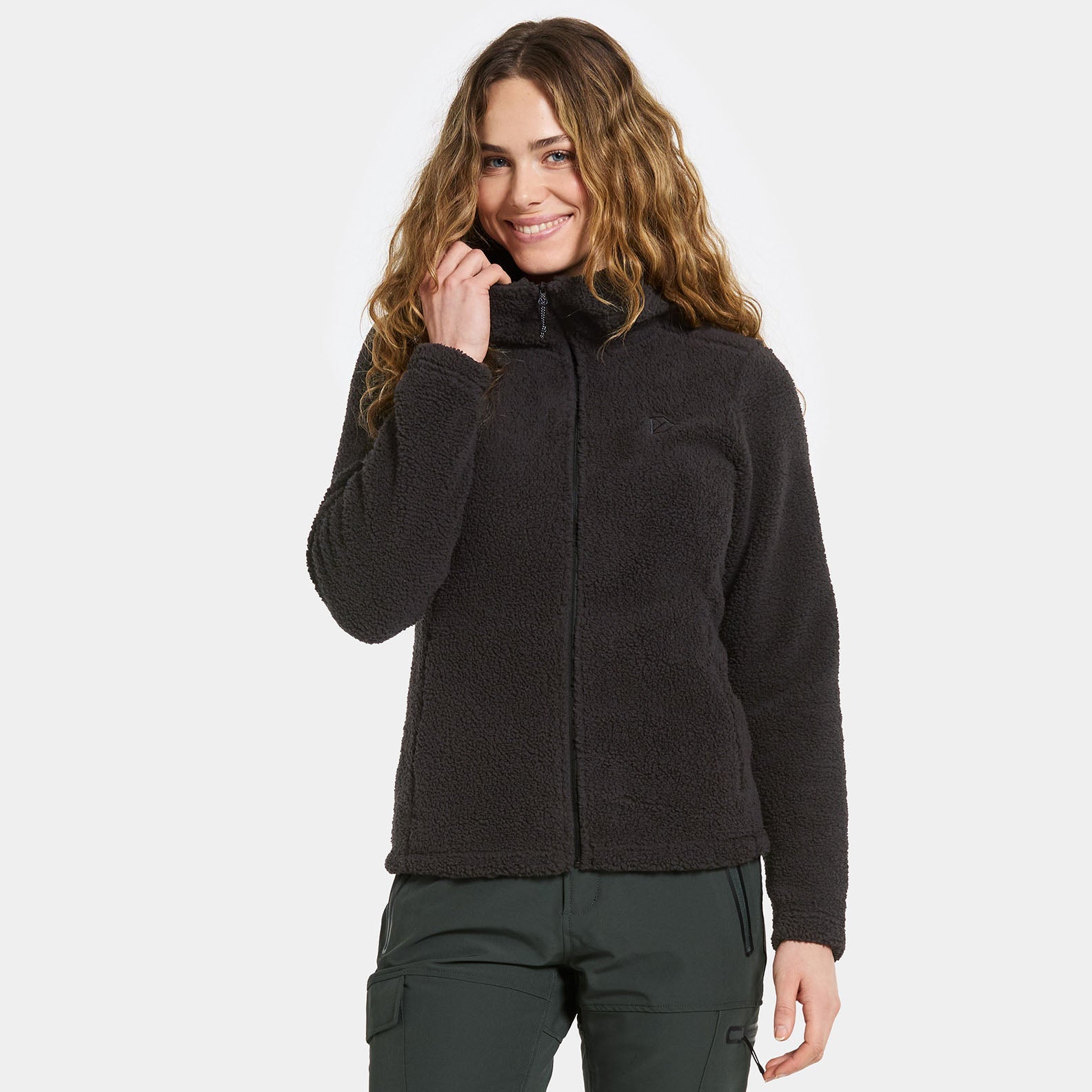 Woman in a black fleece jacket, perfect for country clothing and outdoor adventures