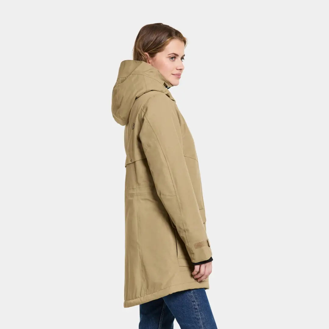 Beige hooded coat over jeans showcasing Didriksons Frida Womens Parka 7 style