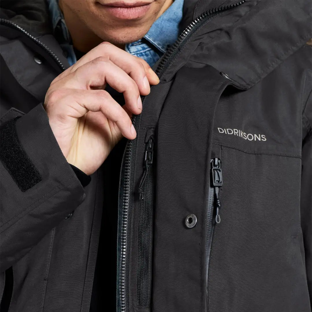 Black Didriksons Marco Parka 3 winter jacket for outdoor adventures with zippered pockets