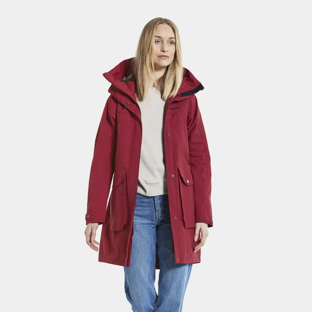 Woman in a red hooded Didriksons Thelma Womens Parka made from woven nylon fabric