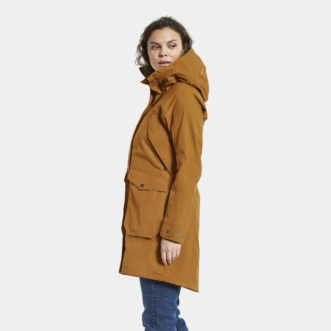 Mustard-colored Didriksons Thelma Womens Parka 8 in woven nylon fabric, styled with jeans