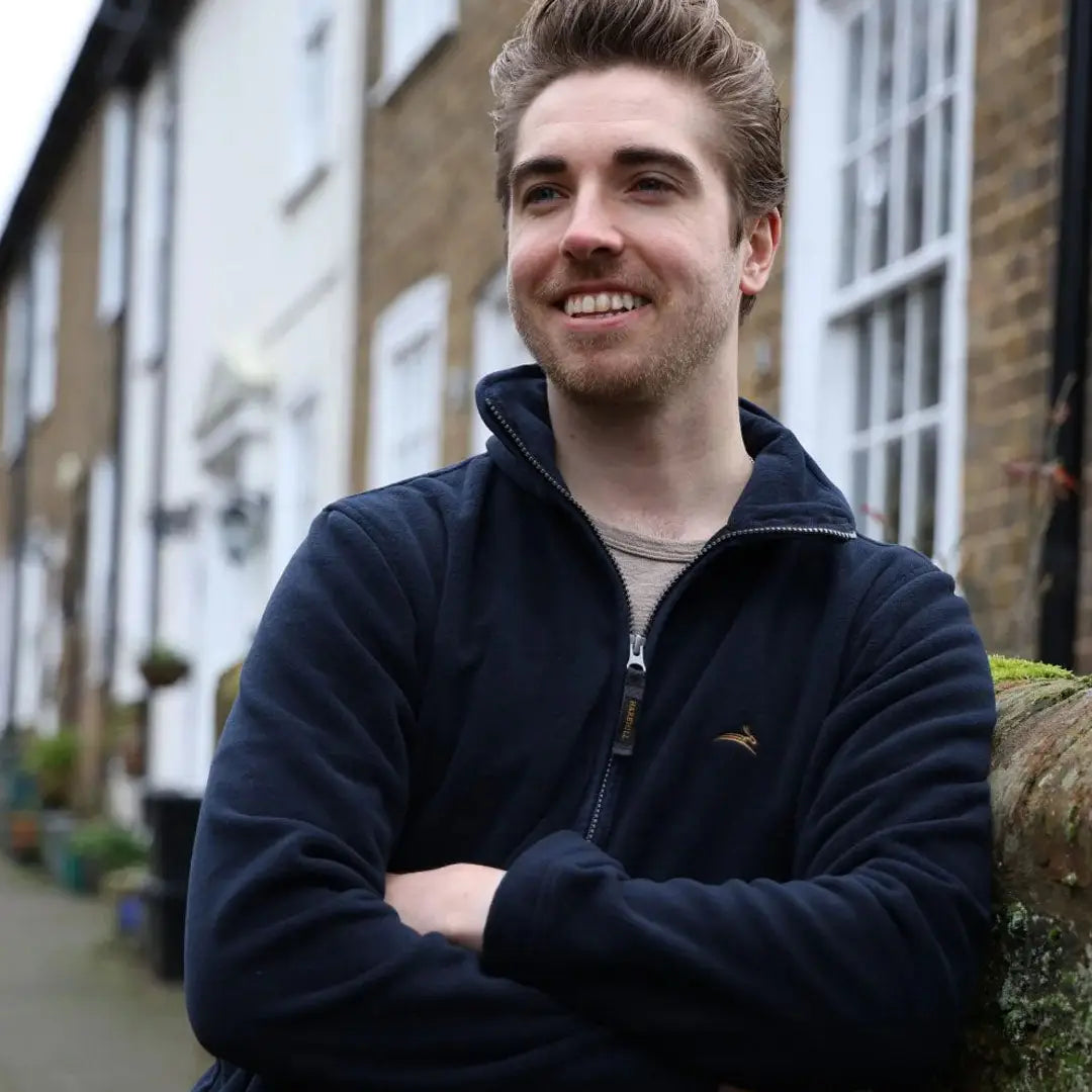 Smiling young man in navy zip-up jacket showcasing the Birtles Fleece outer layer