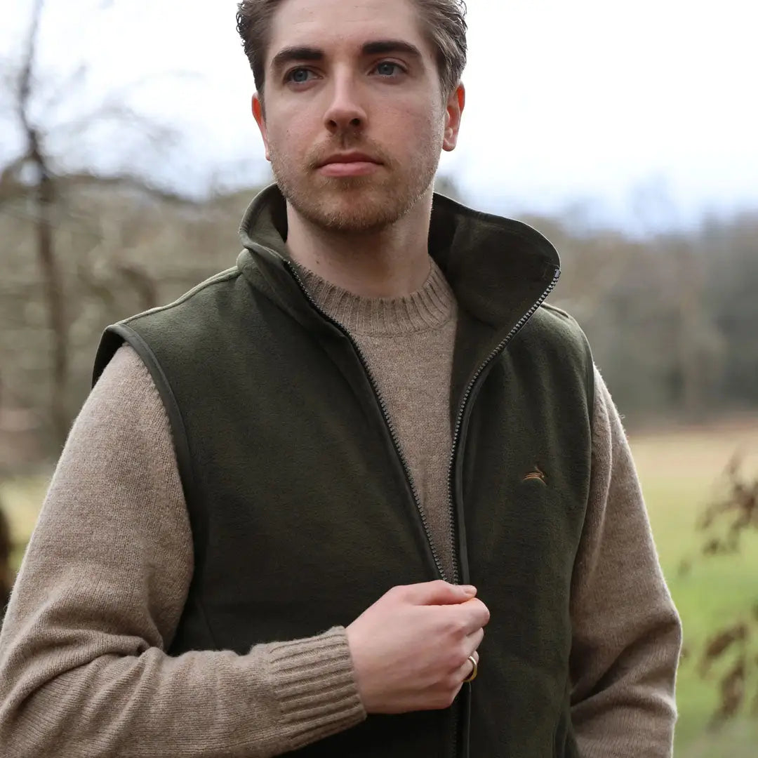 Man in a dark green vest over a beige sweater, perfect for Rural Cheshire style