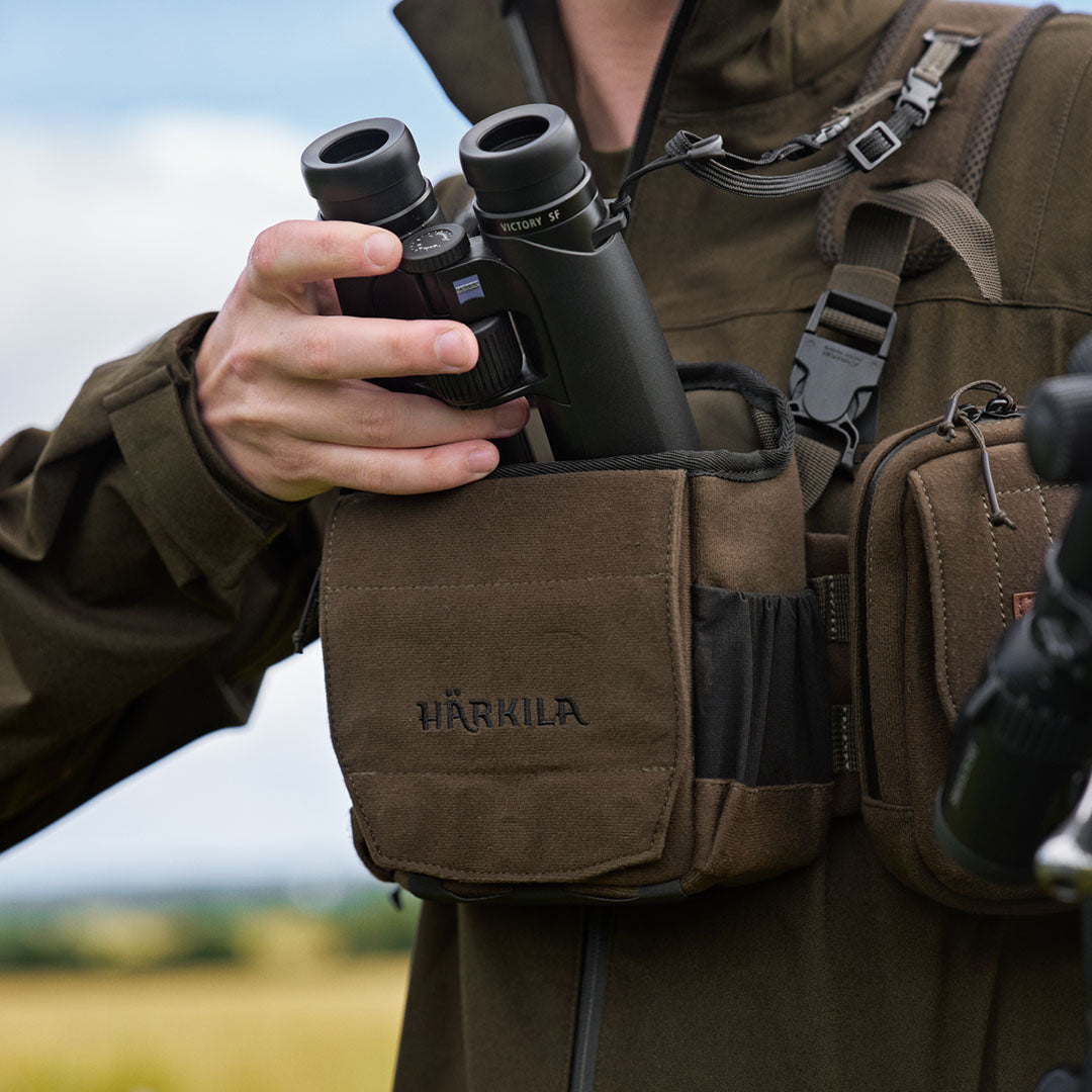 Binoculars in a Harkila Bino Harness perfect for country clothing and hunting adventures