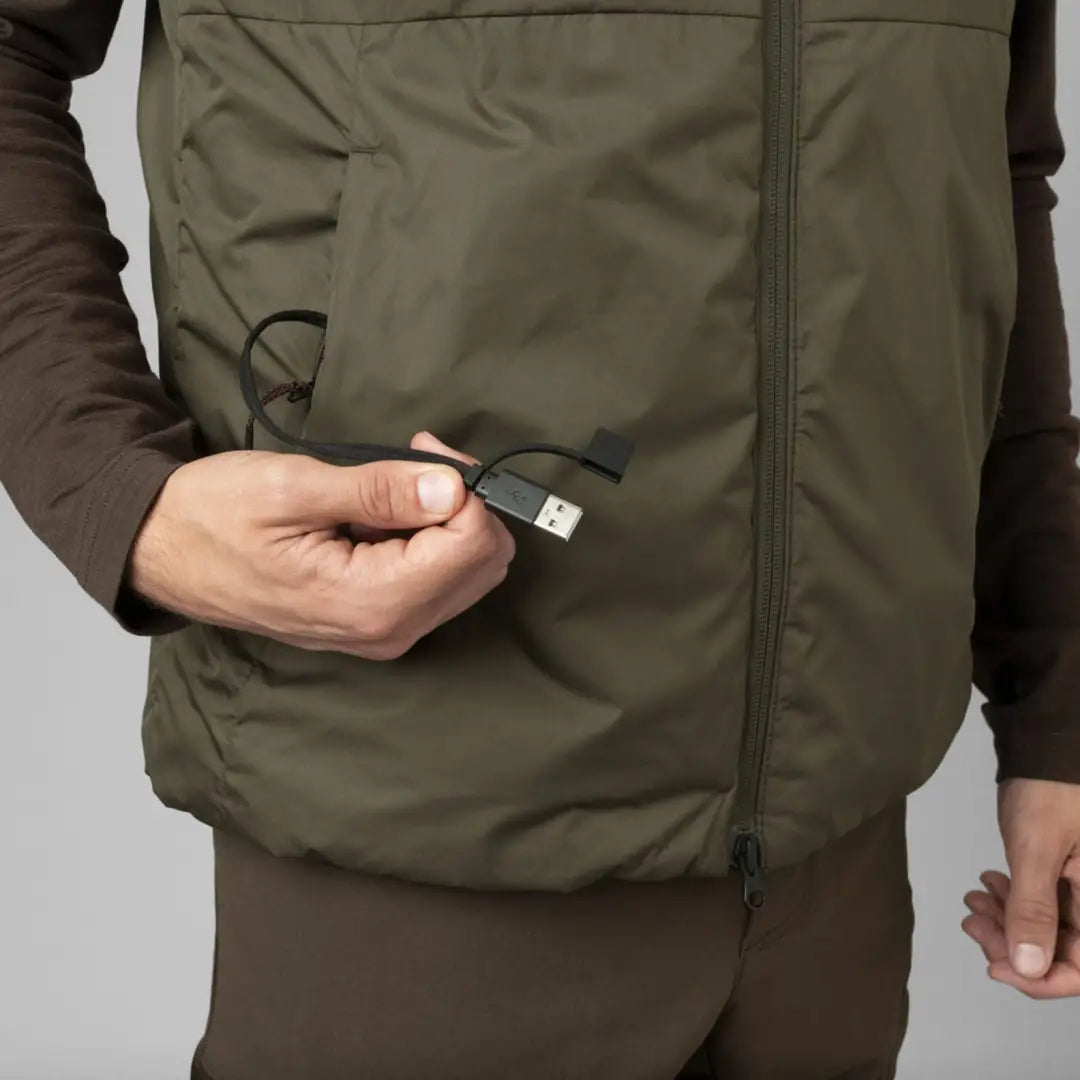 Olive green puffy Clim8 Base Waistcoat with a zipper worn by a person