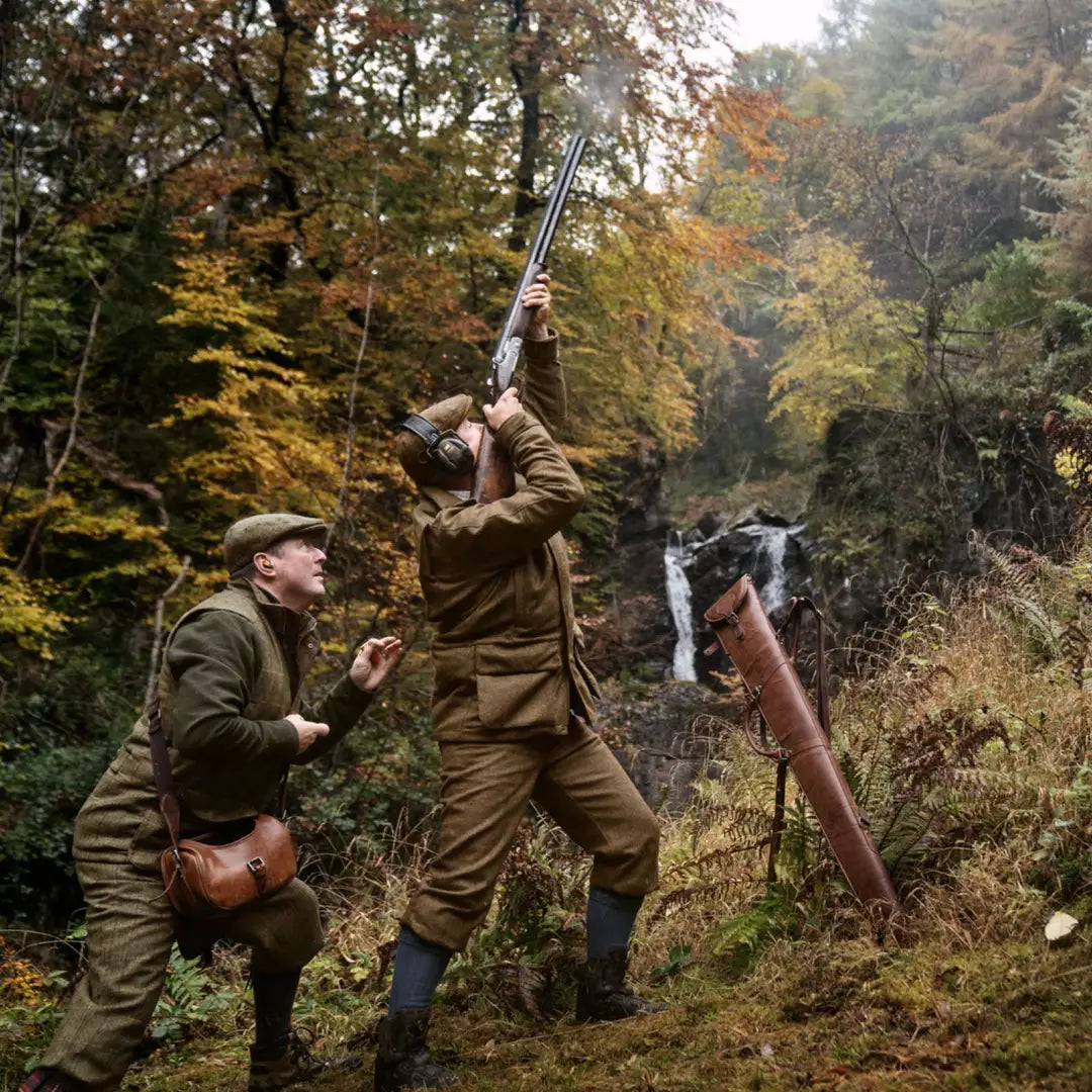 Two hunters in traditional attire aiming shotguns, showcasing the Kenmore GTX Jacket