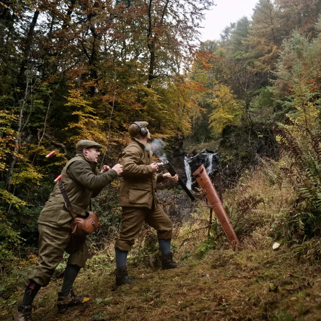 Two hunters in traditional attire sporting the Kenmore GTX Jacket in an autumn forest