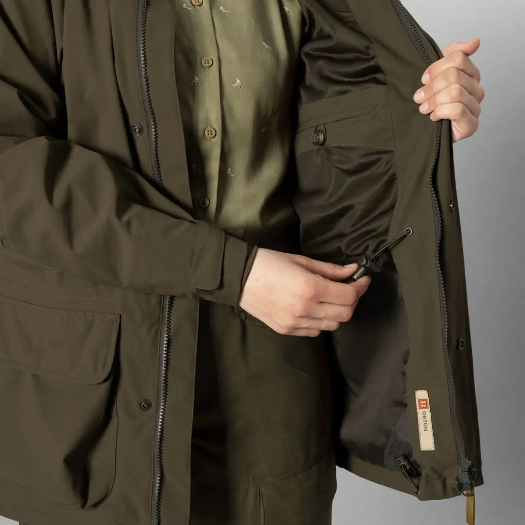 Olive green Orton Tech HWS Jacket for women featuring pockets and zipper closure