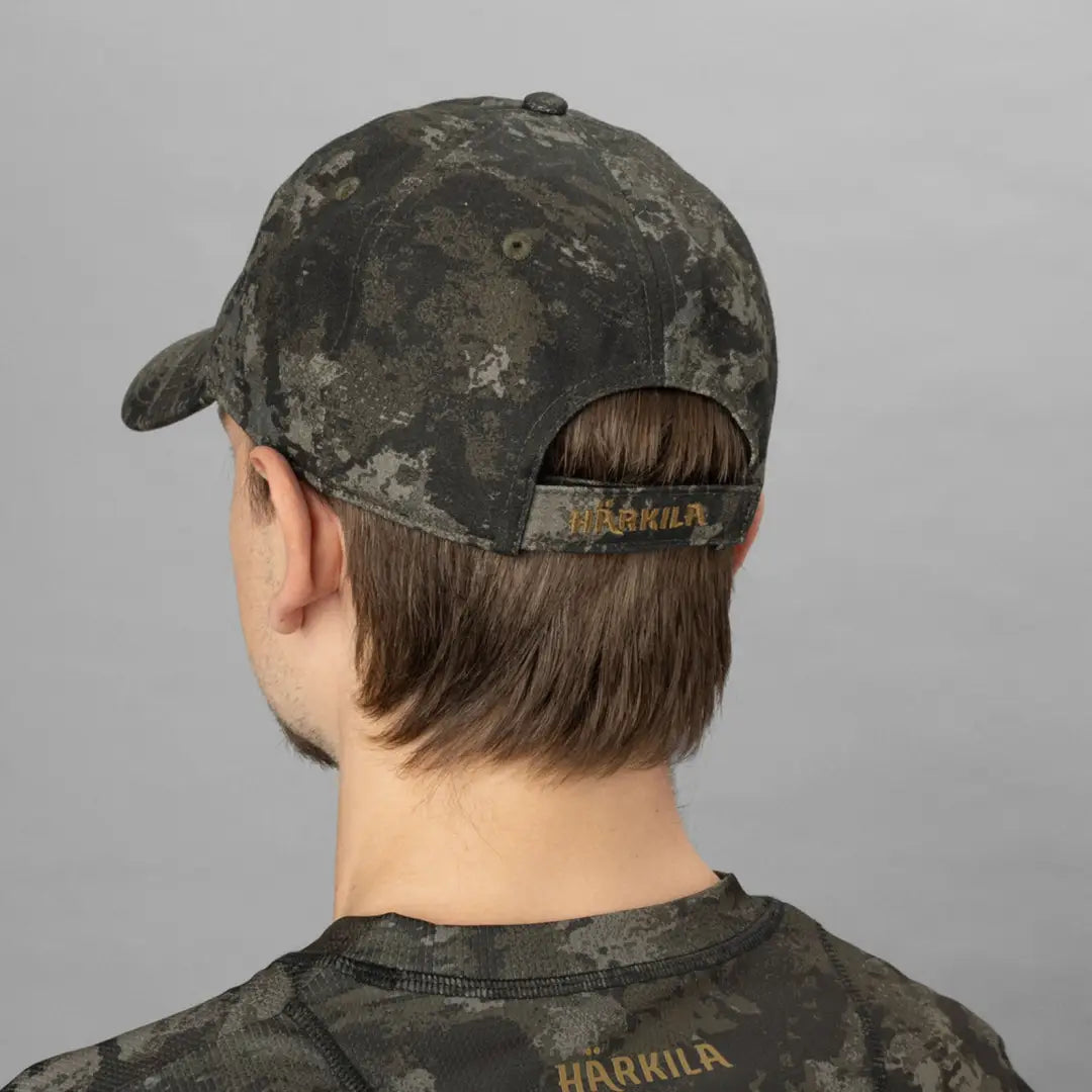 Harkila Modi Camo Cap styled backward on a person for a cool, casual look