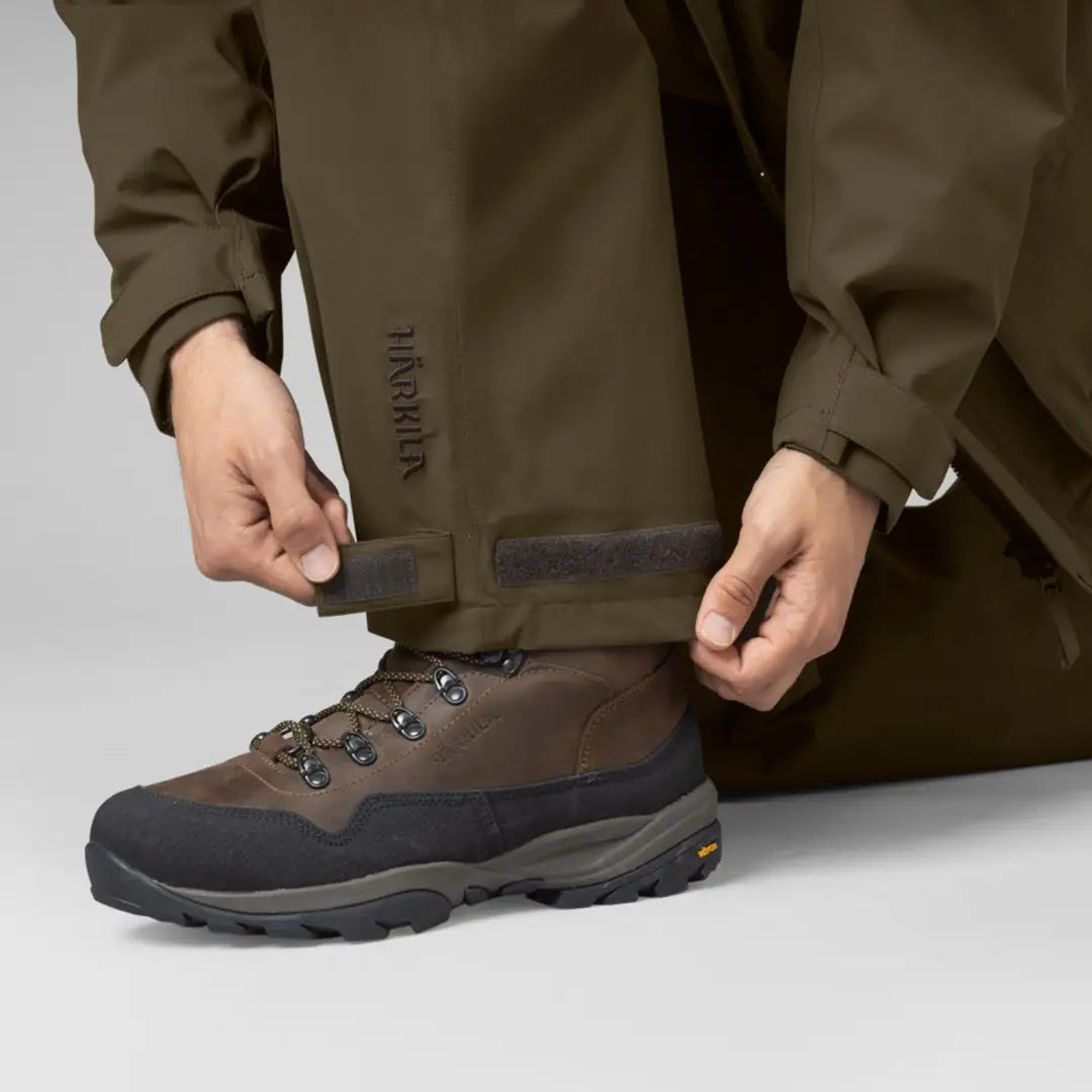 Hiking boot with brown leather upper and black rubber sole for Harkila Orton Overtrousers