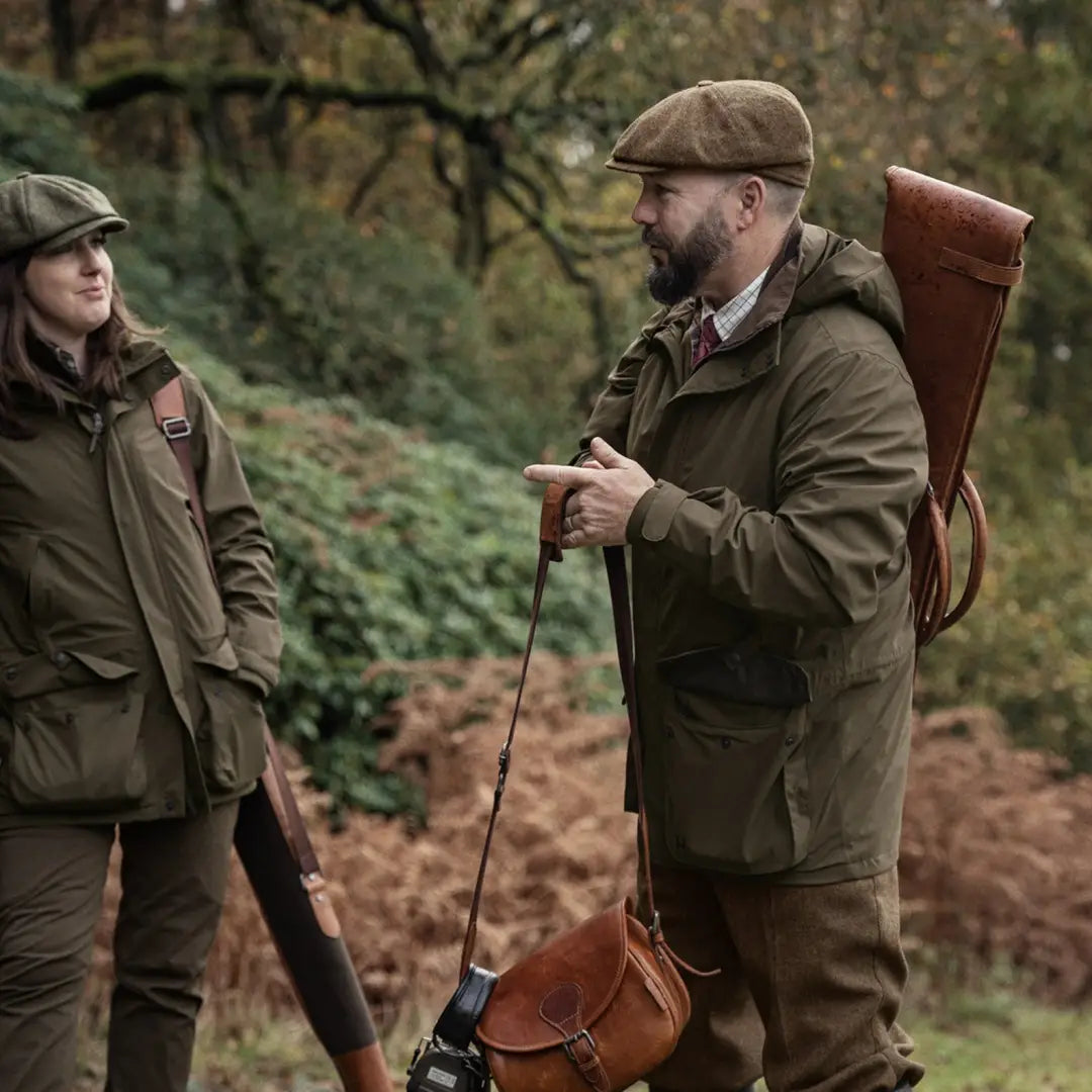 Two people in classic hunting jackets made from stretchy fabric outdoors