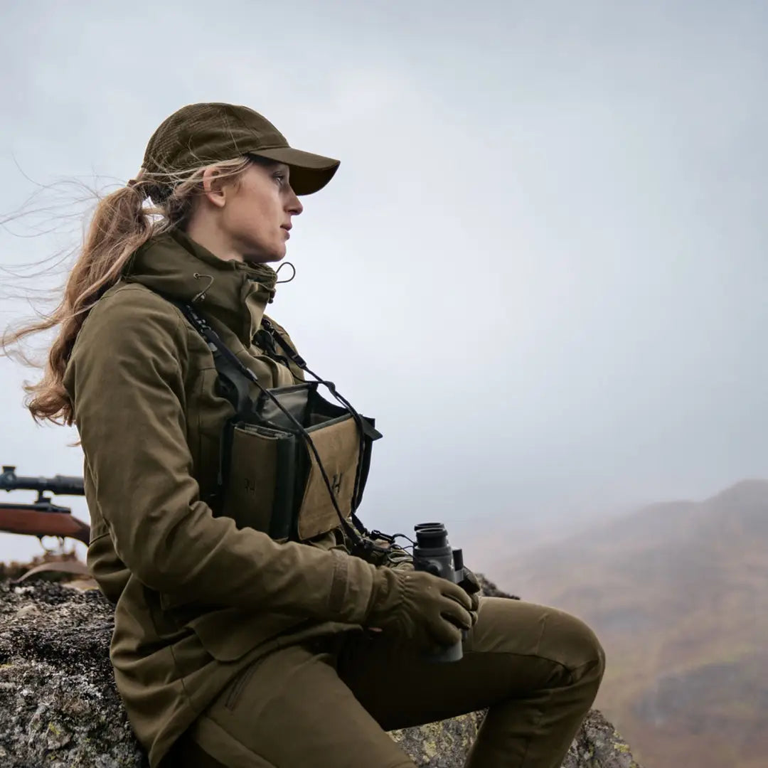 Woman in Harkila Pro Hunter GTX Ladies Jacket with rifle on rocky outcrop