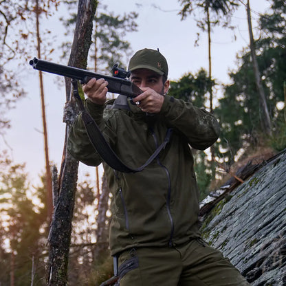 Hunter aiming rifle in woods wearing Harkila Pro Hunter Move 2.0 GTX Jacket with elasticated drawstring