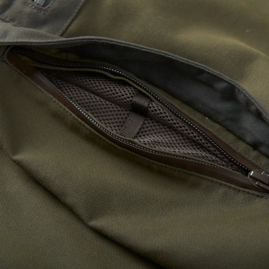 Zippered mesh pocket on olive green Harkila Pro Hunter Move Trousers for strength and style