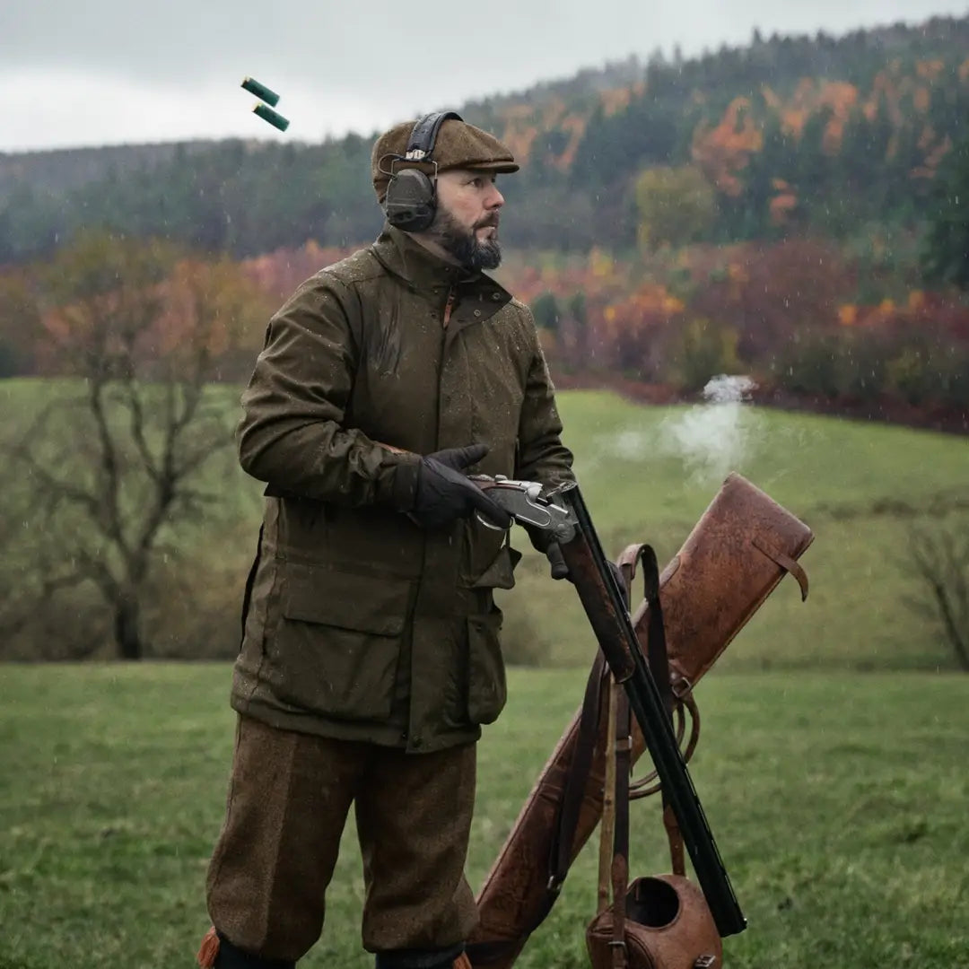 Man in Harkila Pro Hunter Shooting GTX Jacket holding a shotgun in a field