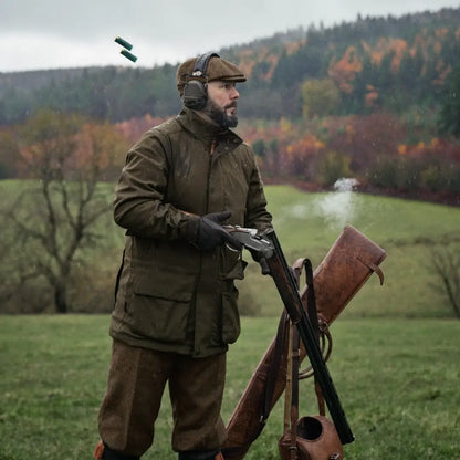 Man in Harkila Pro Hunter Shooting GTX Jacket holding a shotgun in a field