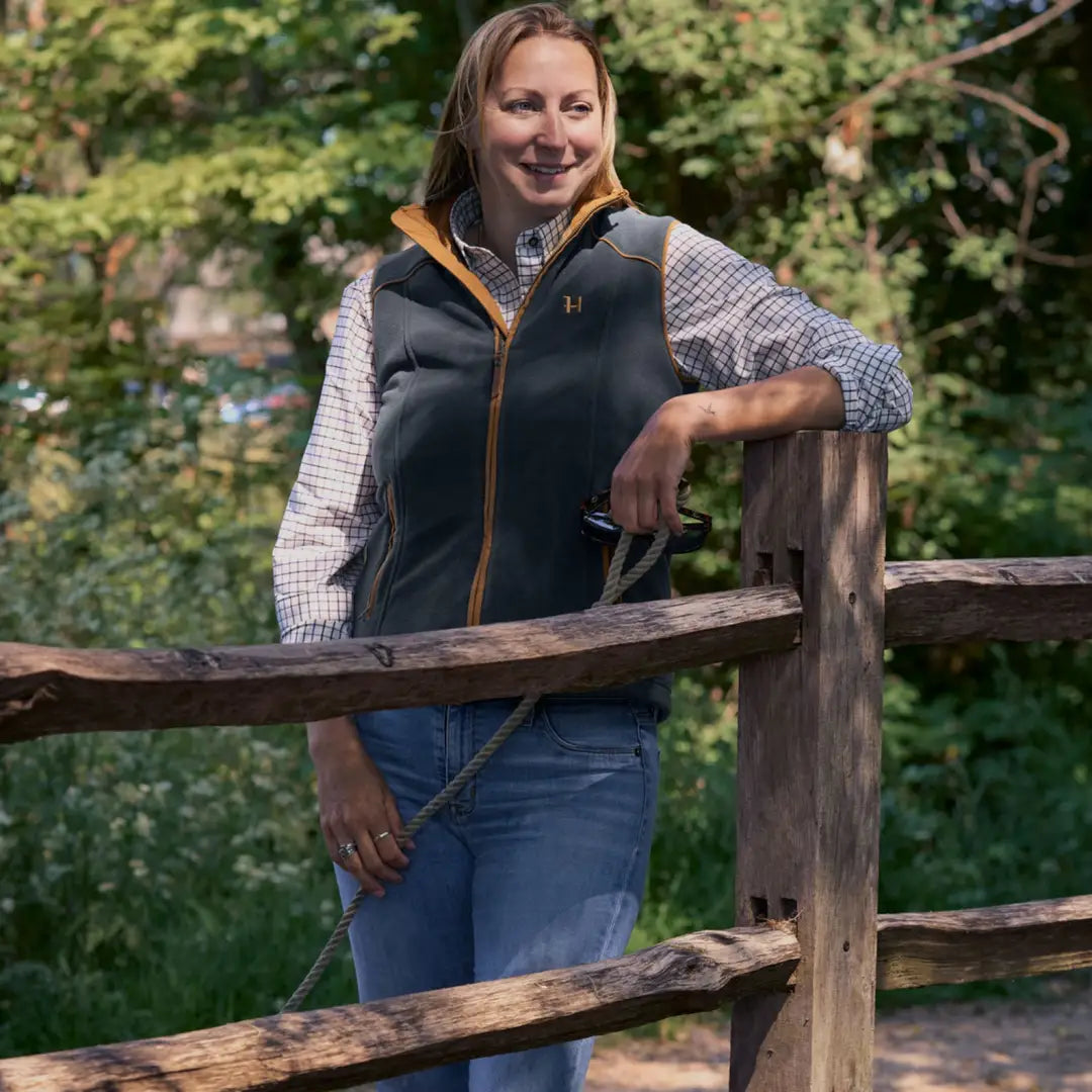 Person in a stylish Harkila Sandhem 200 Ladies Waistcoat, showcasing a female figure perfectly