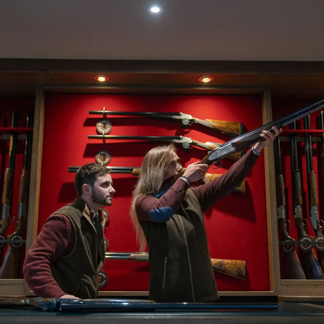 Stylish Harkila Sandhem 200 Ladies Waistcoat on display with people examining firearms