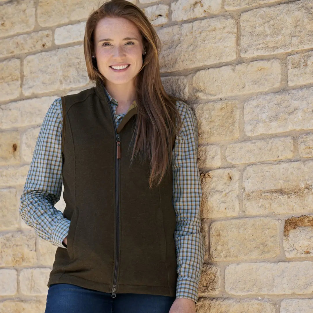 Woman in a dark vest over a checkered shirt showcasing the Sandhem Pro Waistcoat