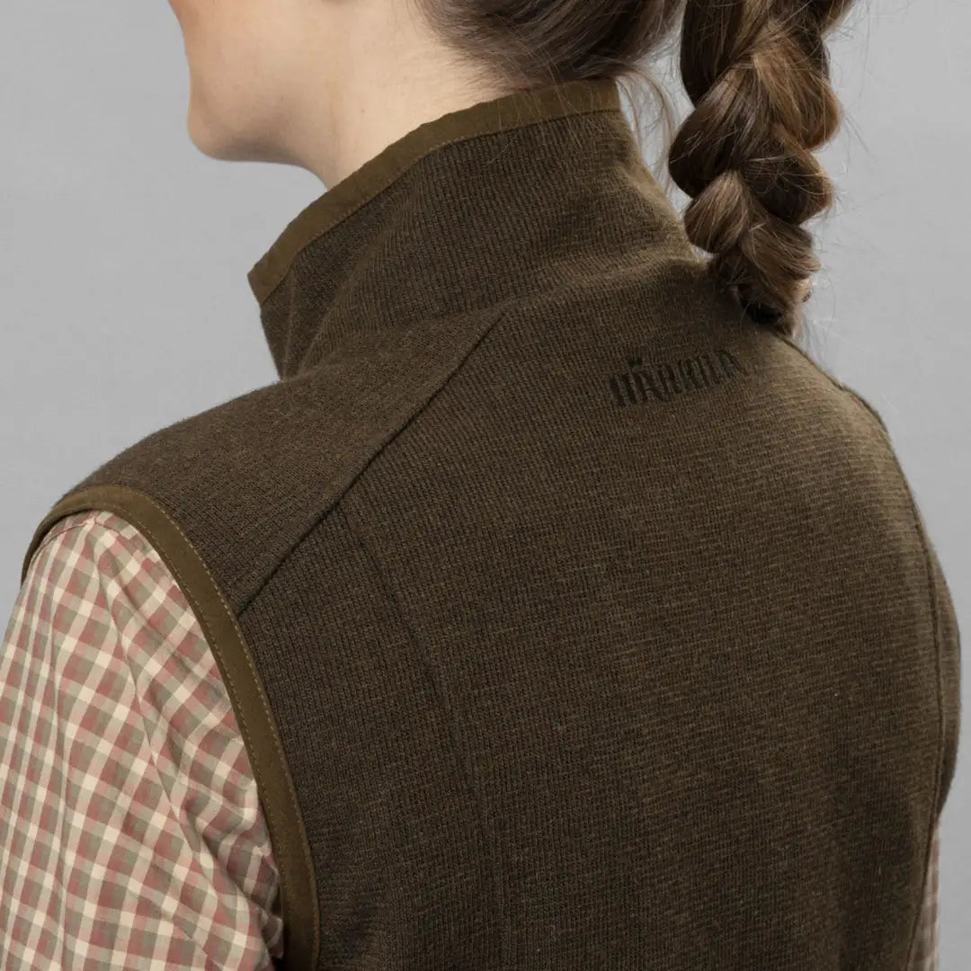 Brown Sandhem Pro Waistcoat over a plaid shirt, made of traditional fleece fabric