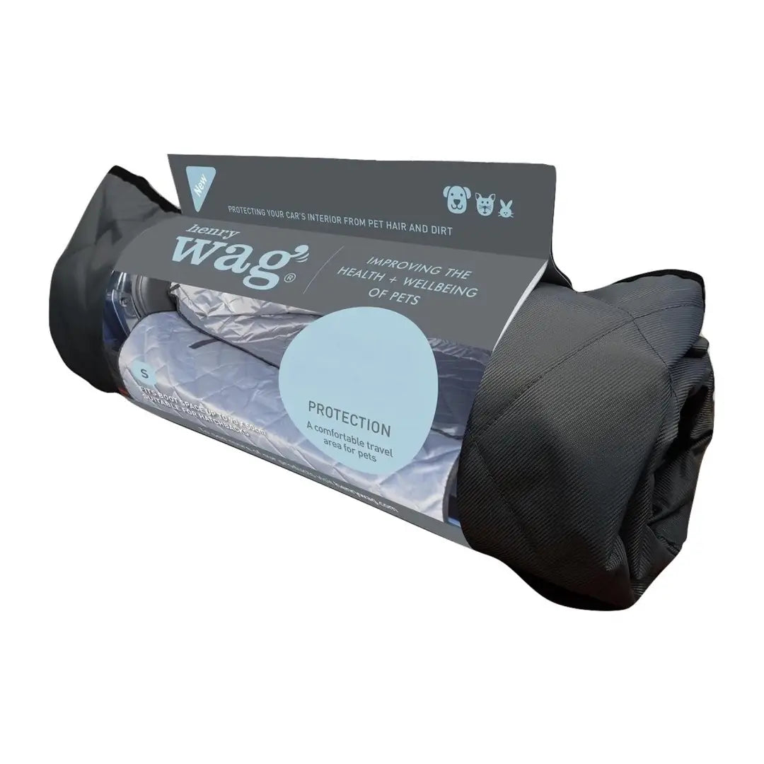 Rolled-up gray sleeping bag in black case next to Henry Wag Pet Car Bench Hammock