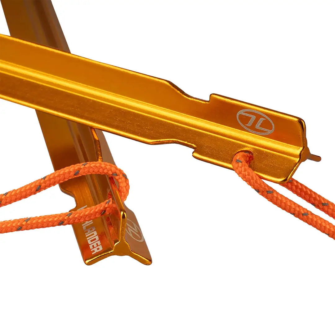 Gold climbing anchor with orange ropes in Highlander Arrow Aluminium Pegs 6 Pack setup