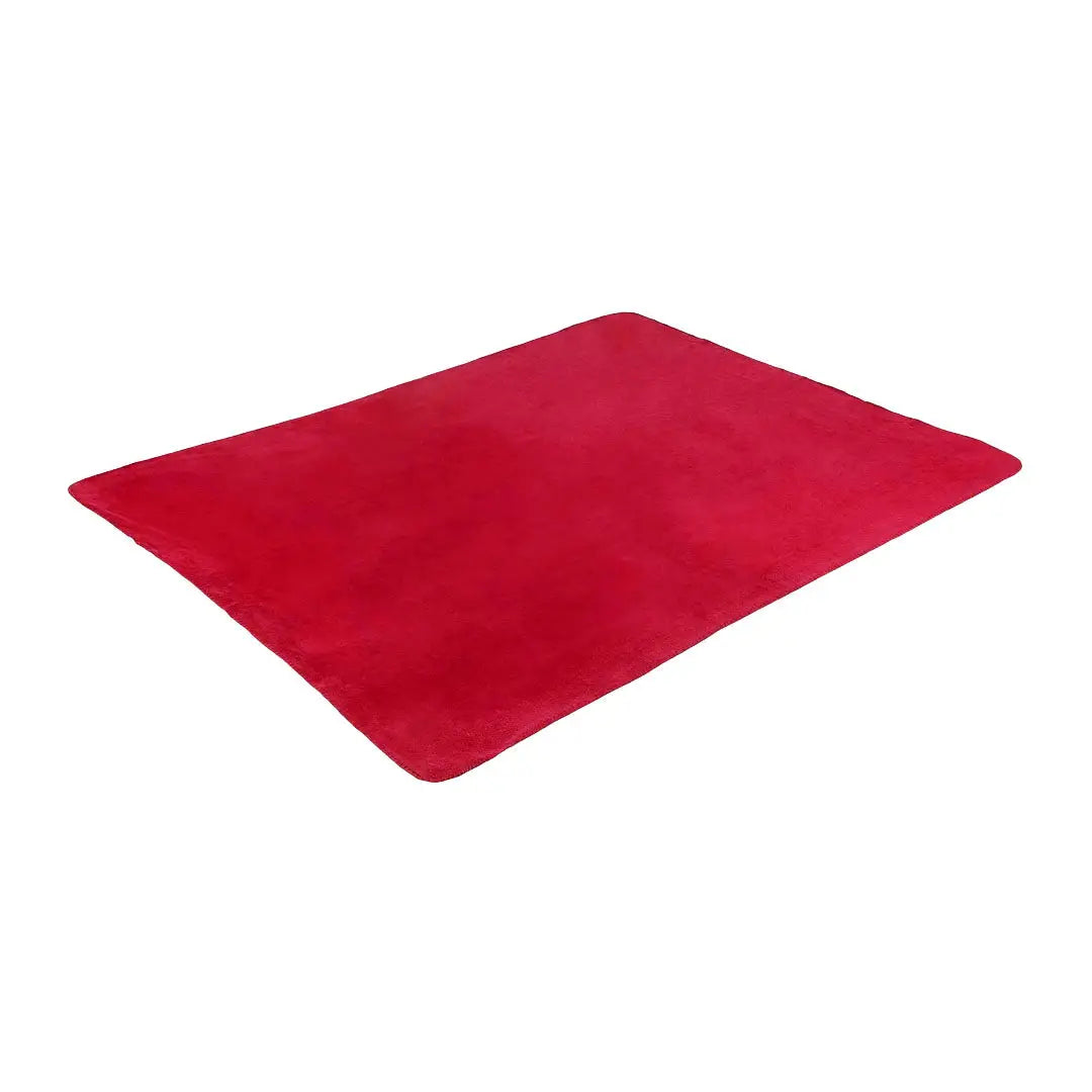 Red silicone baking mat next to Highlander Fleece Blanket for cozy country cooking