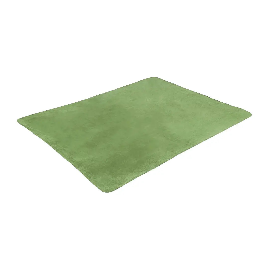 Green silicone baking mat next to Highlander Fleece Blanket for outdoor cooking fun