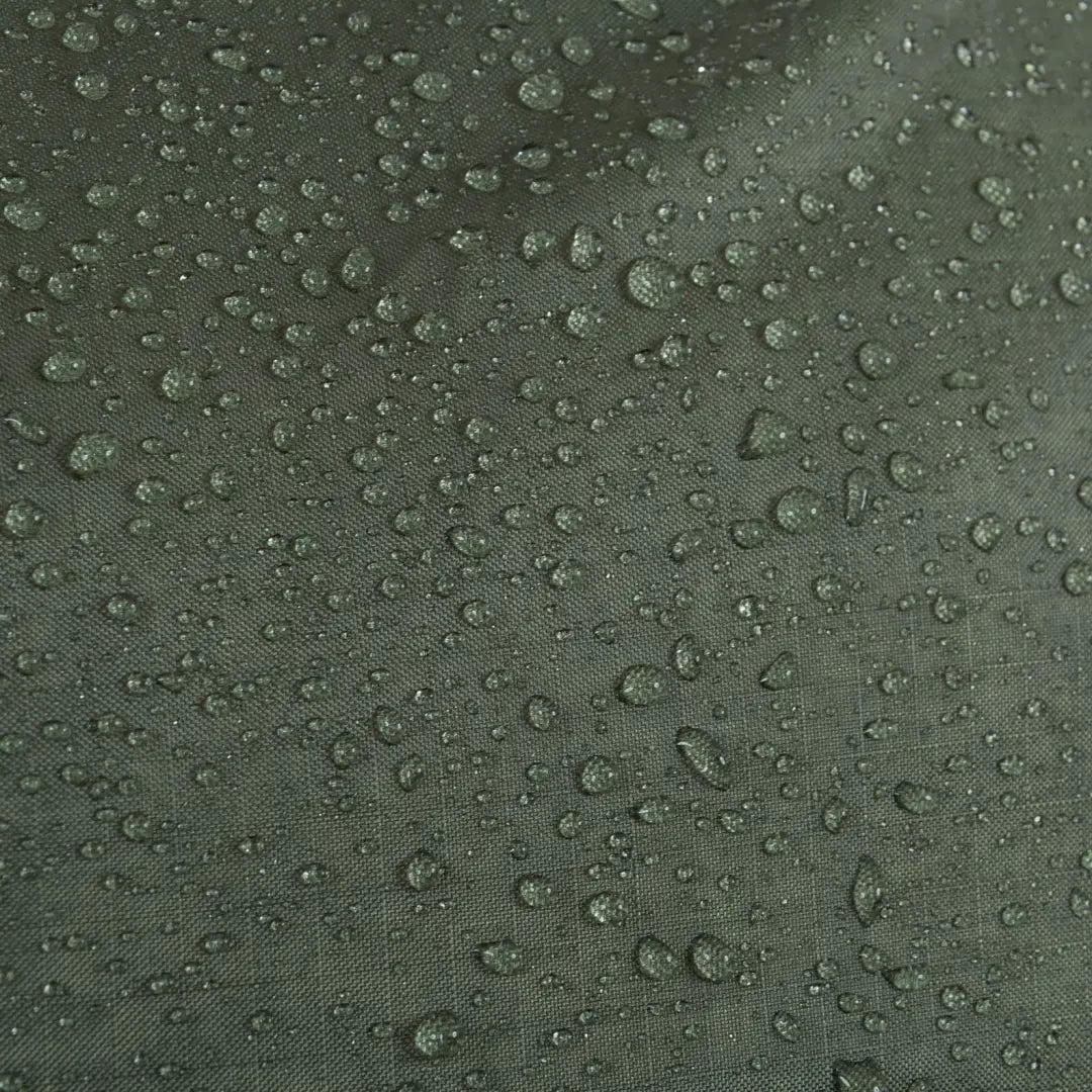 Water droplets on a dark green surface showcasing the Highlander Lightweight Protective Cover