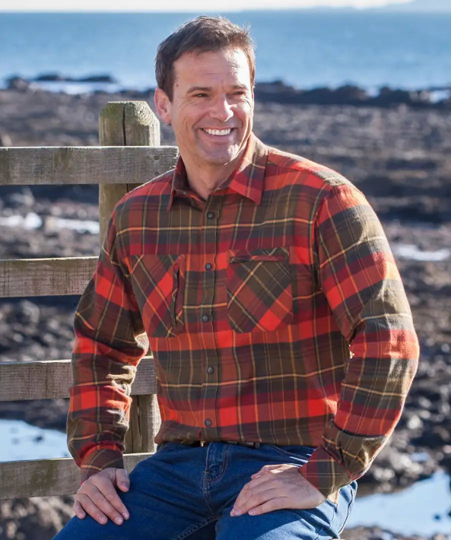 Man in a luxurious long sleeved red and green plaid shirt with two chest pockets