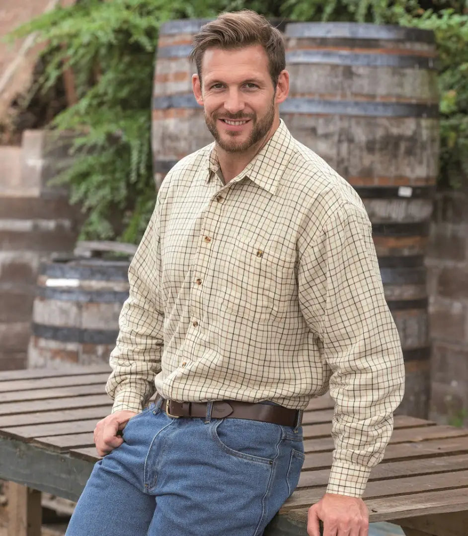 Smiling man in plaid wearing Hoggs Of Fife Birch fleece lined shirt and jeans