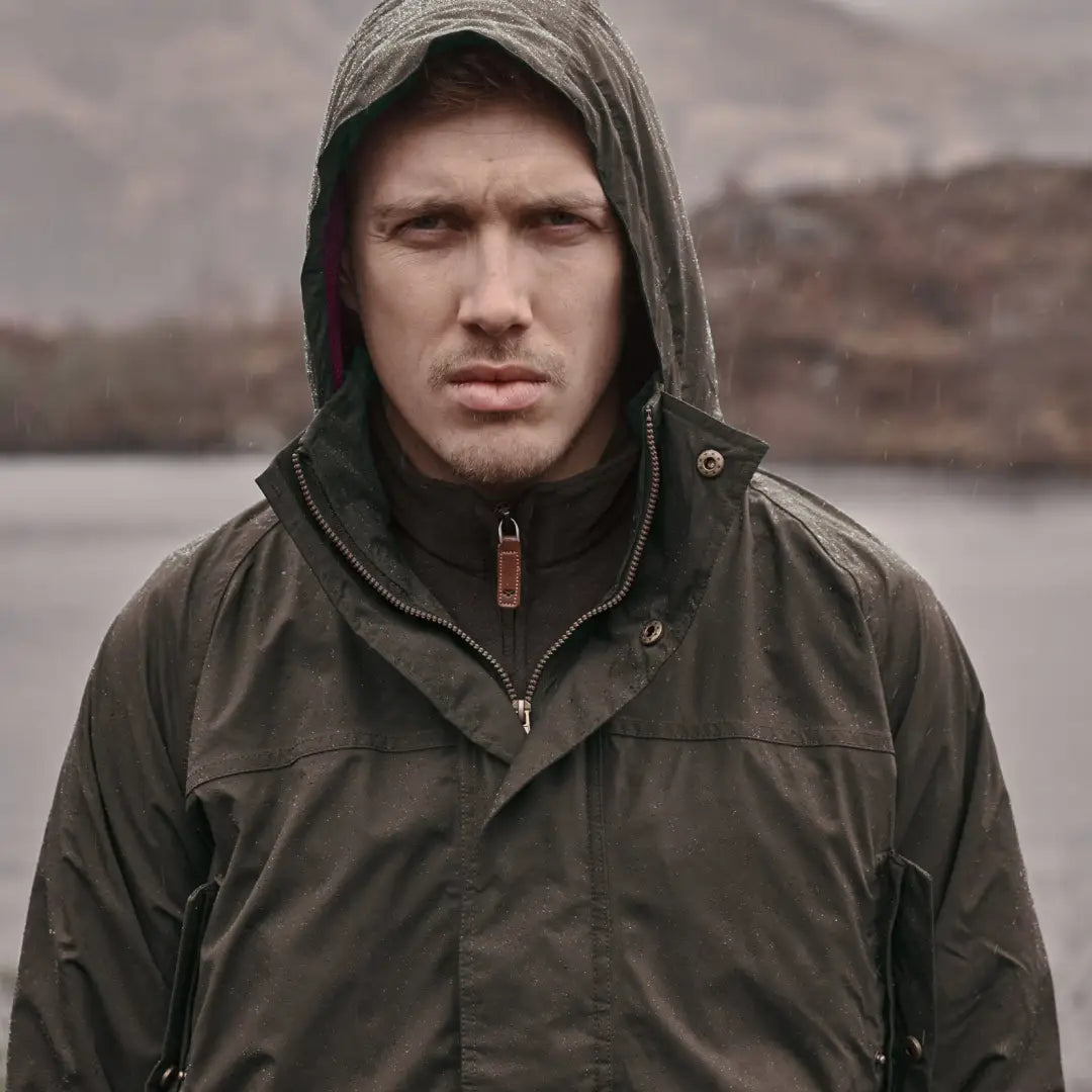 Man in dark hooded jacket, showcasing Fife Culloden waterproof jacket for country clothing