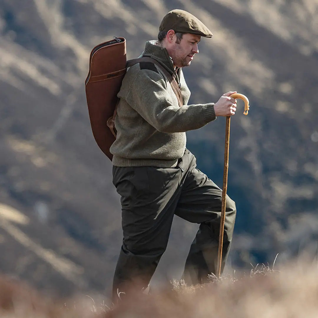 Man in hiking gear with a zip neck windproof pullover and backpack ready for adventure