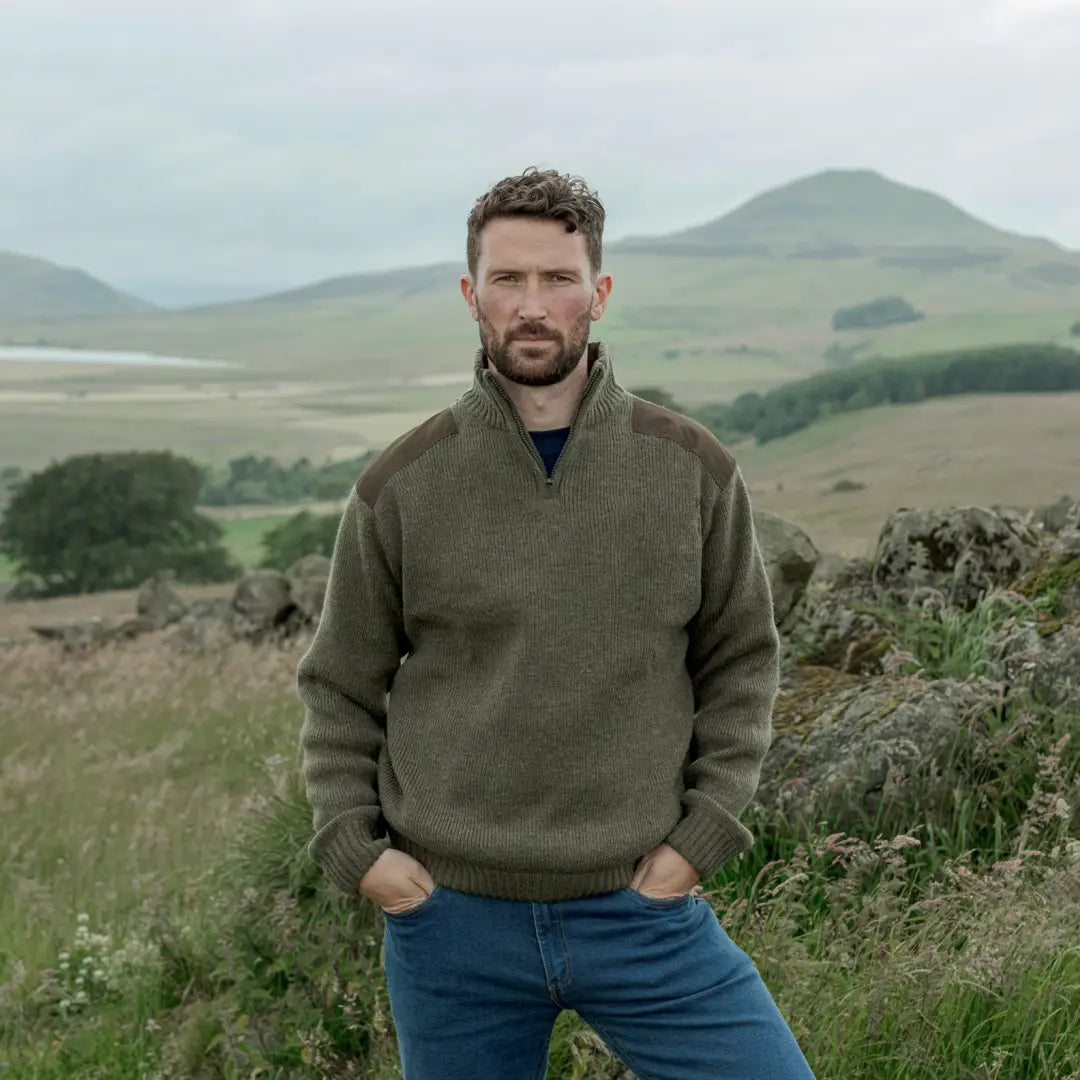 Man in olive green sweater and blue jeans wearing Hebrides Zip Neck Windproof Pullover