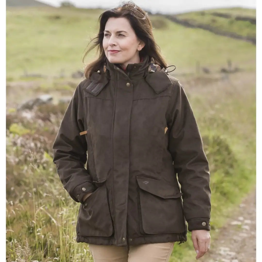 Dark brown ladies hunting jacket with pockets, worn by a woman in a rural setting