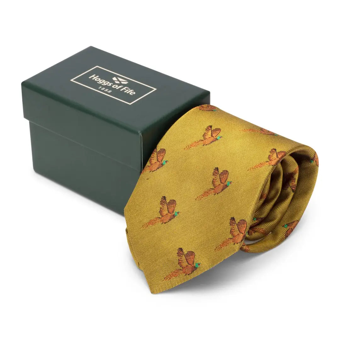 Yellow Hoggs of Fife Silk Country Tie with pheasant pattern beside its green box