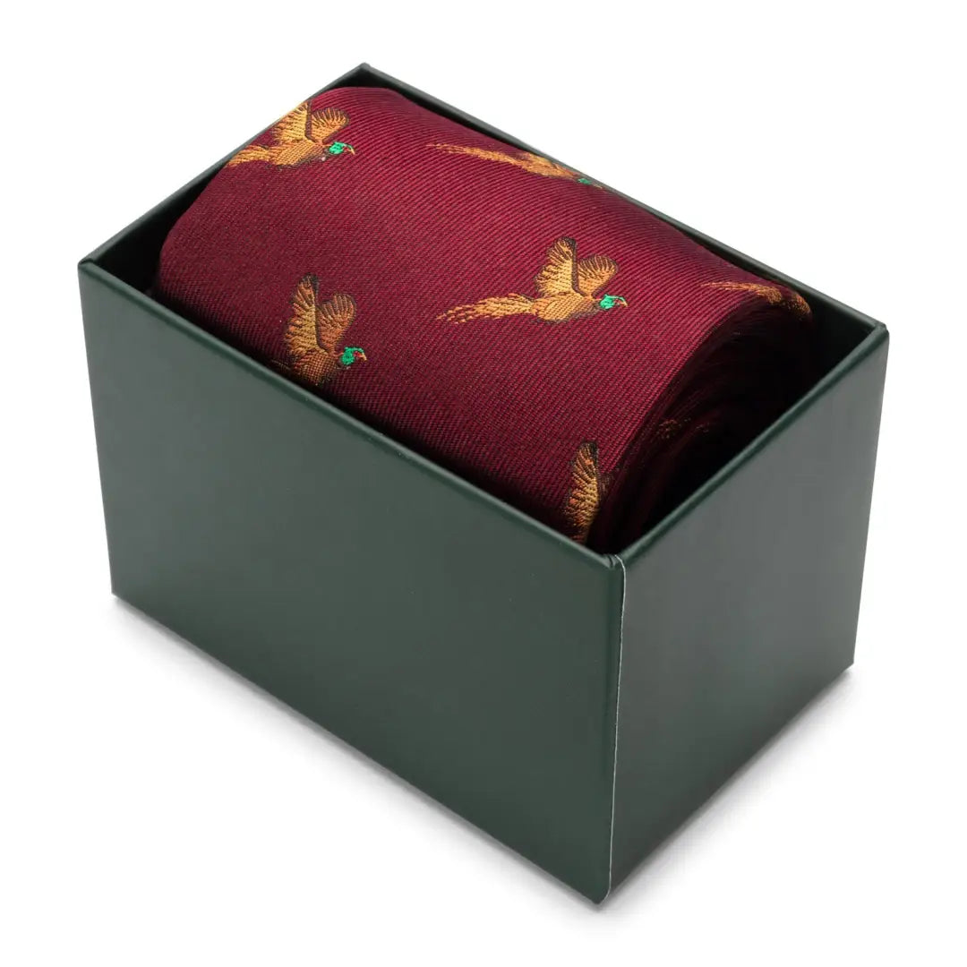 Burgundy necktie with golden pheasant pattern in a box for Hoggs of Fife Silk Country Tie