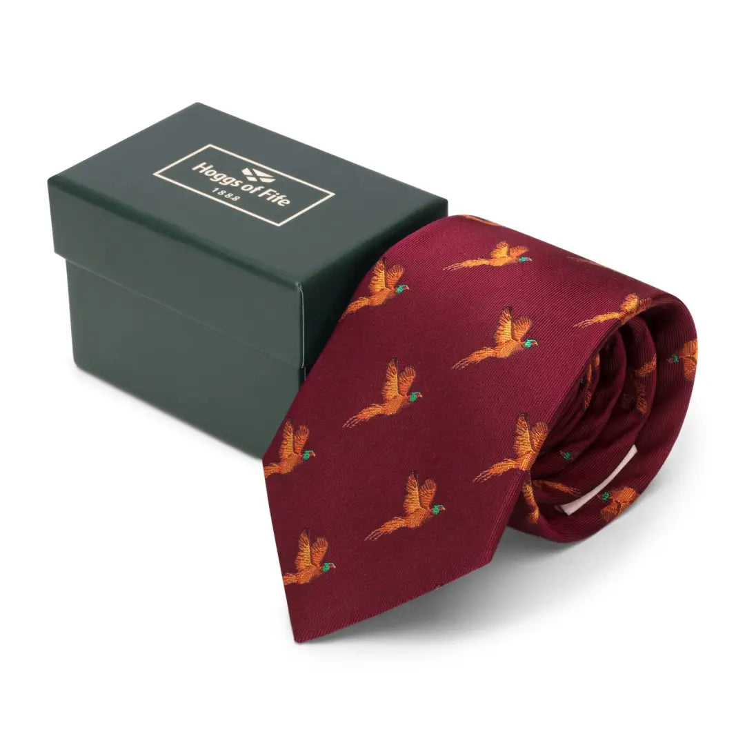 Burgundy Fife Silk Country Tie with golden pheasant pattern beside green box